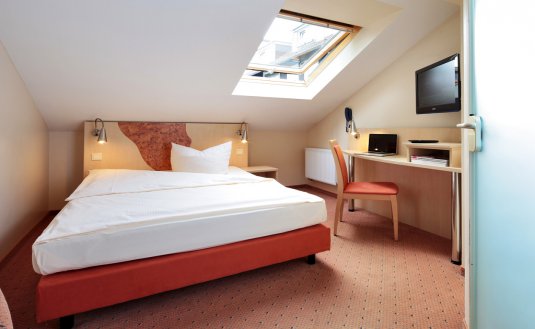 Buntes Zimmer mit Dachschräge im Hotel in Essen-Stoppenberg